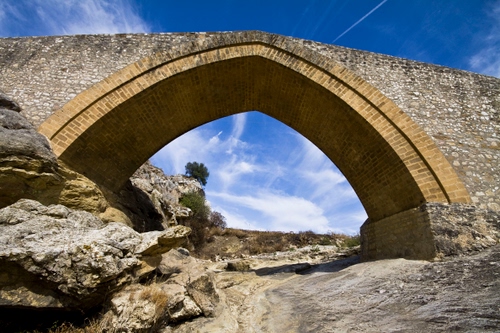 Immagine con ponte, cielo, nuvole, arco, roccia, pietre, sassi, rocce, albero, mattoni