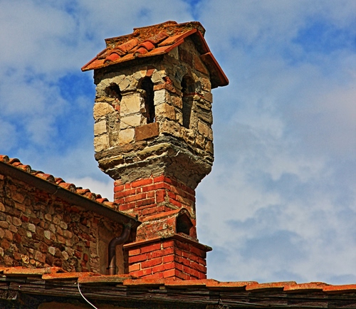 Immagine con mattoni, tetto, nuvole, cielo, comignolo, rosso, camino, tegole, comignoli, pietra
